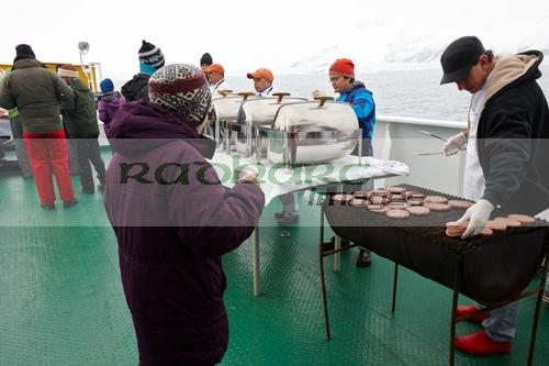 serving bbq lunch passengers on board expedition ship in antarctica