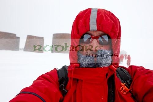 man taking selfie on shore excursion to whaler's bay antarctica