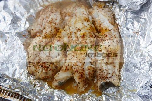  seasoned cod fillets cooked in aluminium foil on a bbq Reykjavik iceland