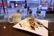 slice-luxury-artisan-sin-cheesecake-with-cup-coffee-in-trees-organic-coffee-house-Vancouver-BC-Canada
