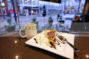 slice-luxury-artisan-sin-cheesecake-with-cup-coffee-in-trees-organic-coffee-house-Vancouver-BC-Canada