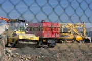 plant-equipment-behind-chain-link-security-fence-on-construction-building-site-in-northern-ireland-uk