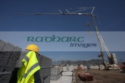 hard-hat-hivis-vest-on-pile-breeze-concrete-building-blocks-with-self-erecting-crane-on-construction-building-site-in-northern-ireland-uk