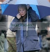 Shirley-MacLaine-shelters-from-the-rain-under-an-umbrella-on-location-for-Sir-Richard-Attenboroughs-latest-film-Closing-the-Ring-in-Belfast,-Northern-Ireland.