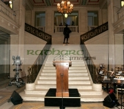 Podium-set-up-in-front-the-staircase-during-final-preparations-underway-in-the-great-hall-at-Stormont-Parliament-Buildings-for-George-Bests-funeral,-Belfast,-Northern-Ireland