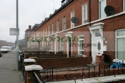 The-former-family-home-Robert-McCartney-partner-Bridgeen-Hagans-white-door-the-Mountpottinger-road-leading-to-PSNI-Police-station-in-the-Short-Strand,-Belfast.-Photo-taken-on-the-eve-his-first-anniversary.