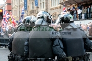 Group-PSNI-Police-Service-Northern-Ireland-riot-police-officers-stand-in-front-loyalist-protesters-at-the-Royal-Irish-Regiment-RIR-Homecoming-Parade-in-Belfast-on-September-02,-2008-in-Belfast,-Northern-Ireland.-The-parade,-which-passed-relatively-peacefully,-was-for-troops-returning-from-Iraq-Afghanistan.