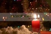 candle-burning-in-the-window-house-with-christmas-tree-in-the-uk-with-snow-on-the-window-sill
