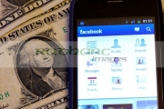 facebook-on-smartphone-cellphone-lying-on-dollar-bills