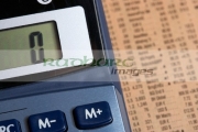 calculator-with-memory-plus-button-focussed-lying-on-copy-the-share-prices-in-the-financial-times
