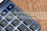 calculator-with-multiplication-button-focus-lying-on-copy-the-share-prices-in-the-financial-times