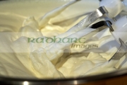 fresh-whipping-cream-whipped-up-in-metal-mixing-bowl-by-an-electric-mixer