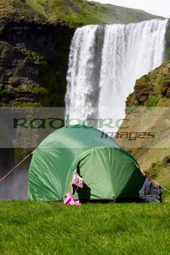 small two person tent with clothes drying camping at skogafoss waterfall iceland
