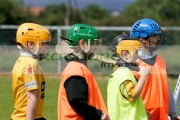 boys-wearing-protective-helmets-one-carrying-stick-listen-to-instruction-on-gaelic-games