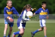 young-girl-tackles-two-young-boys-during-juniort-gaelic-football-game-in-Belfast