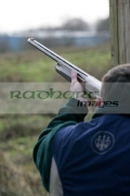 man-recoils-from-firing-shotgun-in-shooting-stand-on-december-shooting-day,-county-antrim,-Northern-Ireland