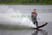 mid-30s-waterskiing-on-fast-high-speed-competition-ski-cutting-through-the-water-generating-huge-splash