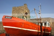 old-fishing-boat-in-front-carrickfergus-castle-in-northern-ireland