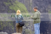 male-blonde-haired-female-tourists-taking-photos-at-the-Cliffs-Moher,-County-Clare,-Republic-Ireland