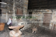Interior-old-blacksmiths-forge-including-tools-anvil-Bunratty-Folk-Park,-County-Clare,-Republic-Ireland