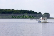 small-tourist-cabin-cruiser-cruising-towards-island-along-lower-lough-erne