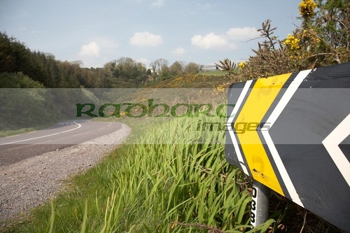 warning-sign-for-dangerous-bend-on-the-main-tourist-route-road-winding-through-fields-the-dingle-peninsula-en-route-to-dingle-county-kerry-republic-ireland