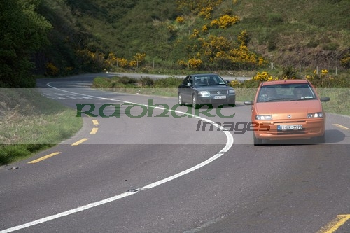 cars-on-narrow-twisy-bend-section-the-main-tourist-route-road-winding-through-fields-the-dingle-peninsula-en-route-to-dingle-county-kerry-republic-ireland