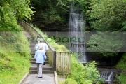 tourists-walking-along-pathway-beside-Glencar-waterfall-county-Leitrim