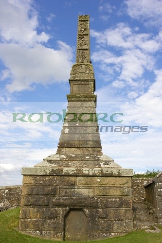 remains-high-stone-celtic-cross-the-OScally-monument-against-blue-cloudy-sky-in-the-Rock-Cashel,-Cashel,-County-Tipperary,-Republic-Ireland