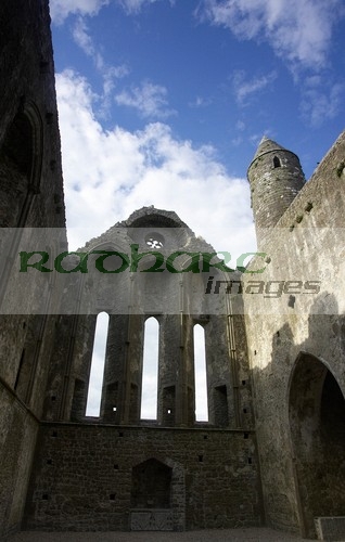 inside-remains-13th-century-cathedral-against-blue-cloudy-sky-in-the-Rock-Cashel,-Cashel,-County-Tipperary,-Republic-Ireland