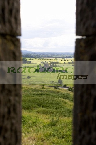 viewpoint-looking-out-through-stone-fortifications-towards-hore-abbey-from-the-Rock-Cashel,-golden-vale-Cashel,-County-Tipperary,-Republic-Ireland