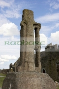 12th-century-cross-St-Patrick-against-blue-cloudy-sky-in-the-Rock-Cashel,-Cashel,-County-Tipperary,-Republic-Ireland