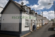 the-row-seamount-row-traditional-fishing-cottages-with-gable-wall-on-hill-in-courtown-harbour