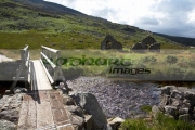 new-wooden-bridge-over-small-stream-leading-to-ruined-old-church-next-to-st-kevins-road-in-the-wicklow-mountains