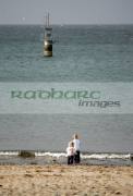 Two-Children-playing-on-Peel-beach-with-harbour-marker-in-the-background-Isle-Man-IOM