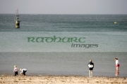 Four-Children-playing-on-Peel-beach-with-harbour-marker-in-the-background-Isle-Man-IOM
