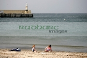two-children-playing-on-Peel-beach-with-harbour-in-the-background-Isle-Man-IOM