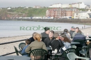 Tourists-sitting-on-plastic-furniture-on-Peel-seafront-Isle-Man-IOM