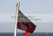 Red-ensign-the-UK-merchant-navy-flying-from-flag-pole-on-ship-at-sea.