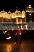 three-female-fire-dancers-street-entertainers-perform-in-front-crowd-at-the-cloth-hall-in-krakow