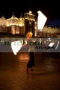 blonde-female-fire-dancer-street-entertainer-performs-in-front-the-cloth-hall-in-krakow