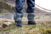 hiker-hillwalker-wearing-boots-waterproof-trousers-in-the-highlands-Scotland-UK