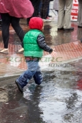 young-boy-splashing-through-puddles-in-rain-shower-in-the-uk