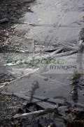 thin-layer-ice-formed-on-rural-track-on-cold-frosty-winter-morning-in-ireland
