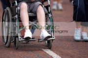 boy-in-wheelchair-being-pushed-along-road-