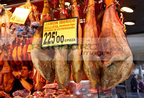 jamon iberico hams hanging inside the la boqueria market in Barcelona Catalonia Spain