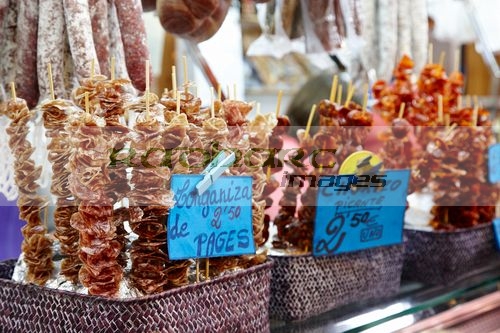 snack dried sausage on sticks inside the la boqueria market in Barcelona Catalonia Spain