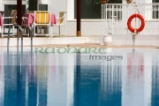 steps-red-lifebelt-reflection-in-still-blue-swimming-pool-in-resort-hotel-hammamet-tunisia