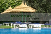 sun-loungers-straw-protective-parasols-by-the-pool-in-resort-hotel-hammamet-tunisia