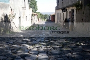 street-sighs-the-oldest-street-in-the-Barrio-Historico-Colonia-Del-Sacramento-Uruguay-South-America-The-street-is-portuguese-in-design-with-the-drain-in-the-middle-old-colonial-houses